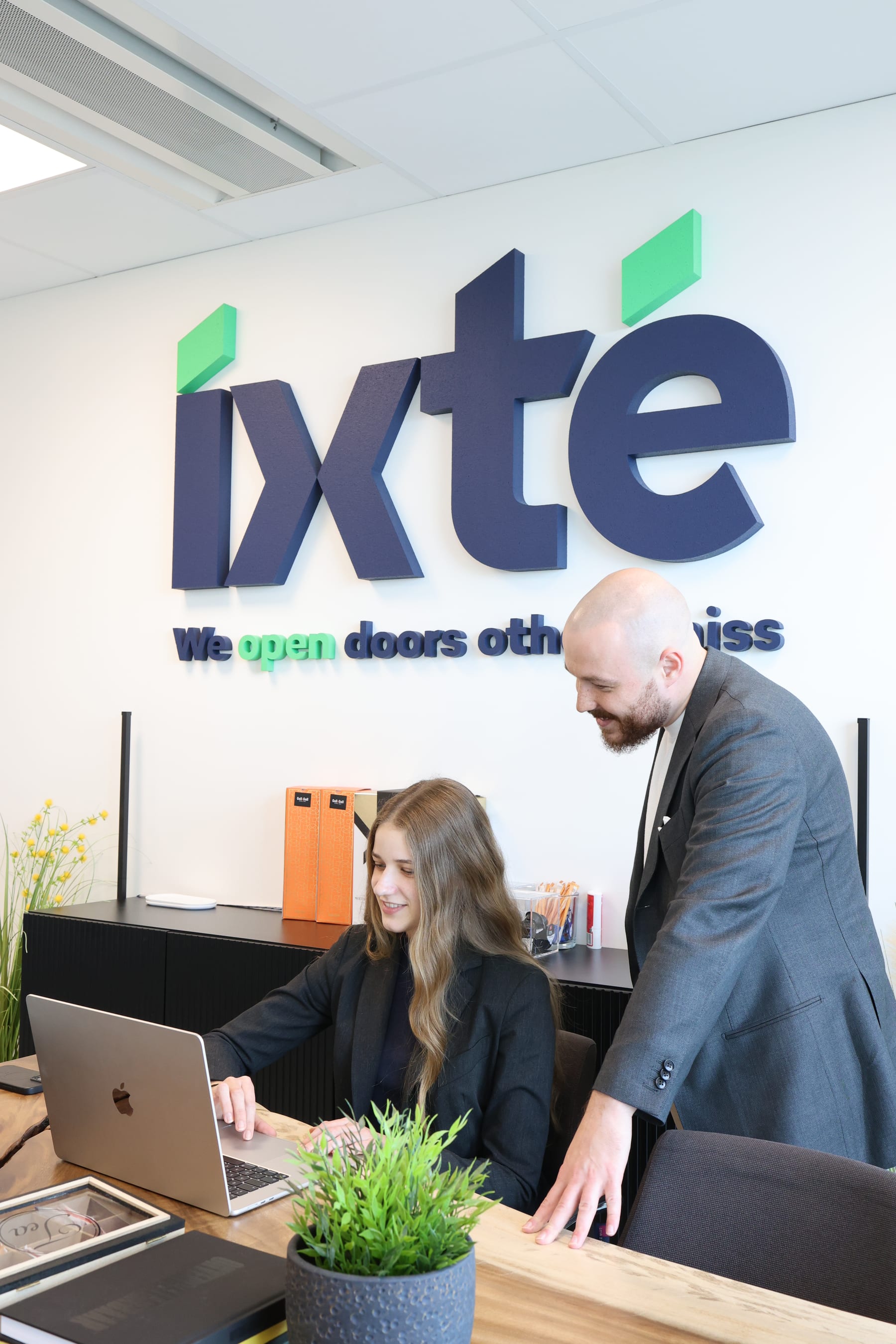 Overleg bij het bureau onder het IXTE-logo